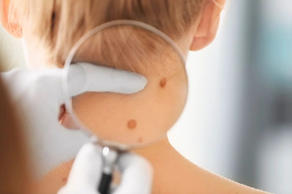Traveler checking their shoulder and arm in natural clinic light