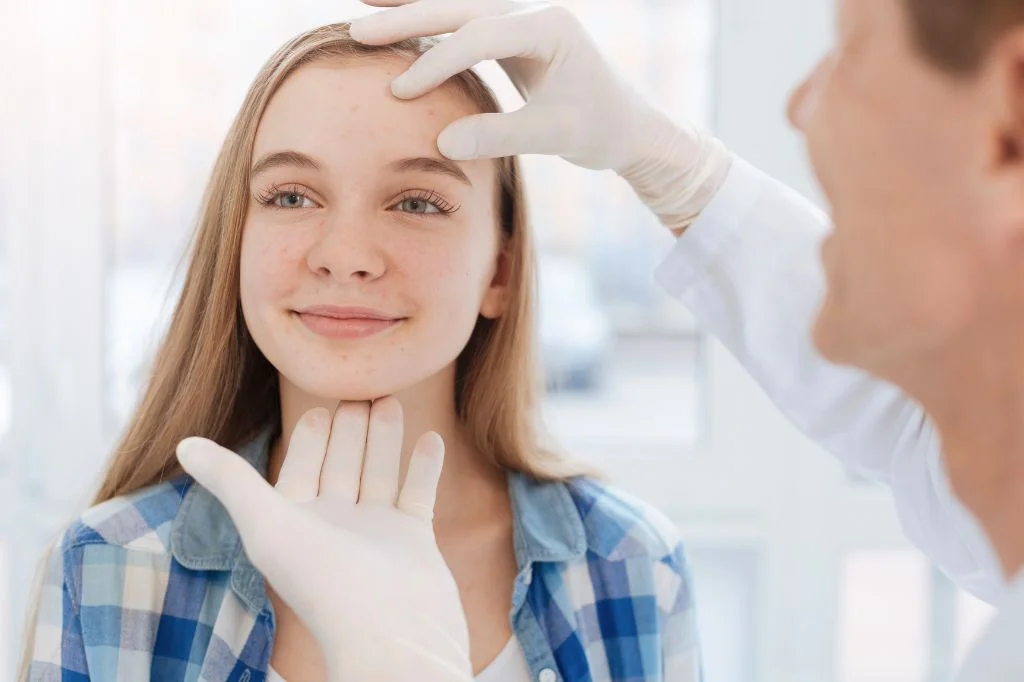 Dermatologist consulting with a patient in a bright clinic room