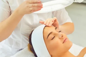 Dermatologist conducting a facial analysis consultation with a patient in a bright Bali clinic