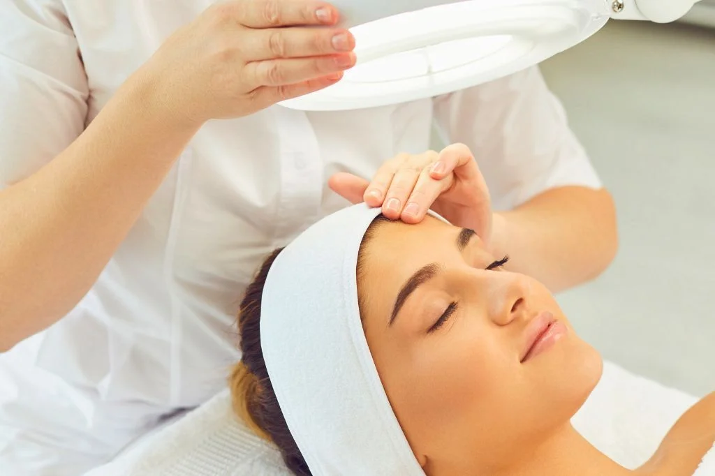 Dermatologist conducting a facial analysis consultation with a patient in a bright Bali clinic