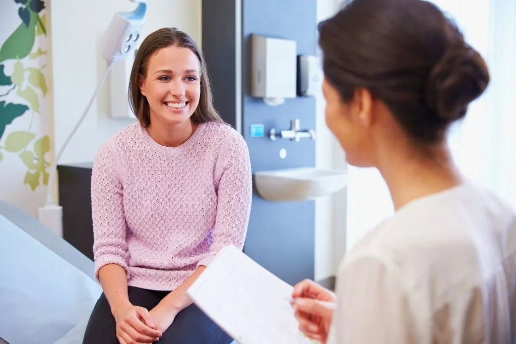 Dermatologist conducting a close, individualized assessment with a patient in a Bali clinic