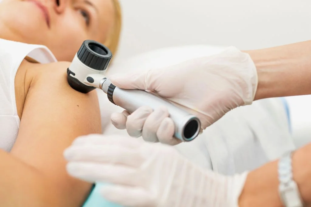 A traveler getting checked at a clinic by a dermatoscope