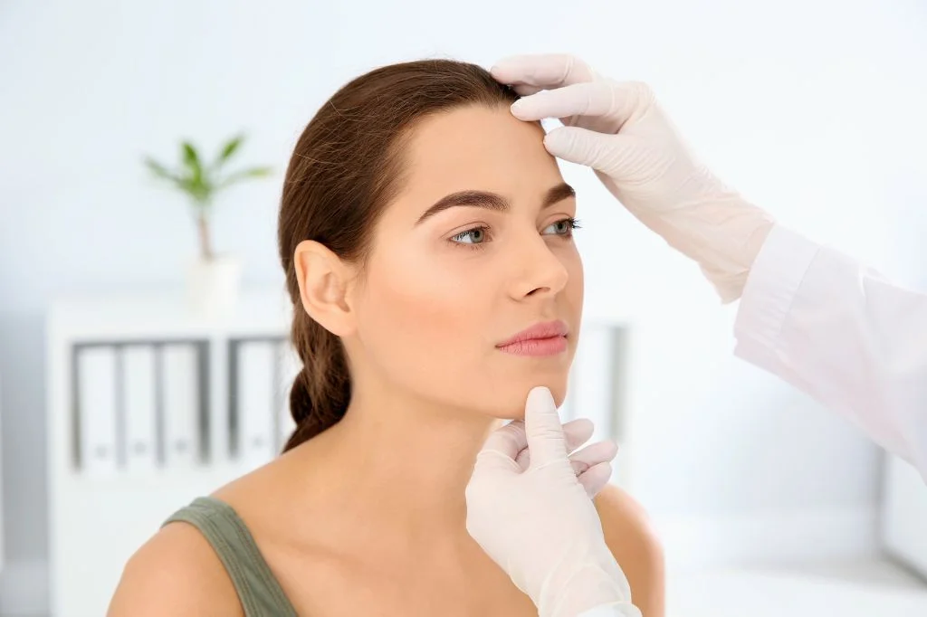 Dermatologist doing an examination on the patient's skin, especially on the face