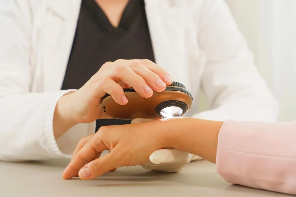 Dermatologist examining a patient's hand and wrist at a Bali clinic