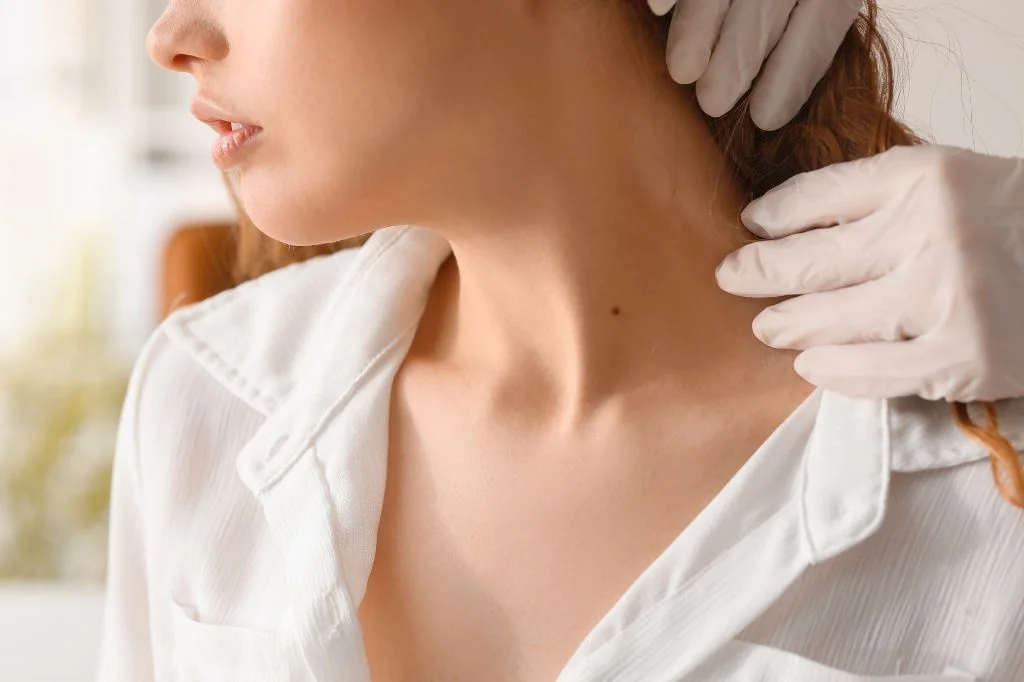 Dermatologist looking at the mole on the tourist's neck