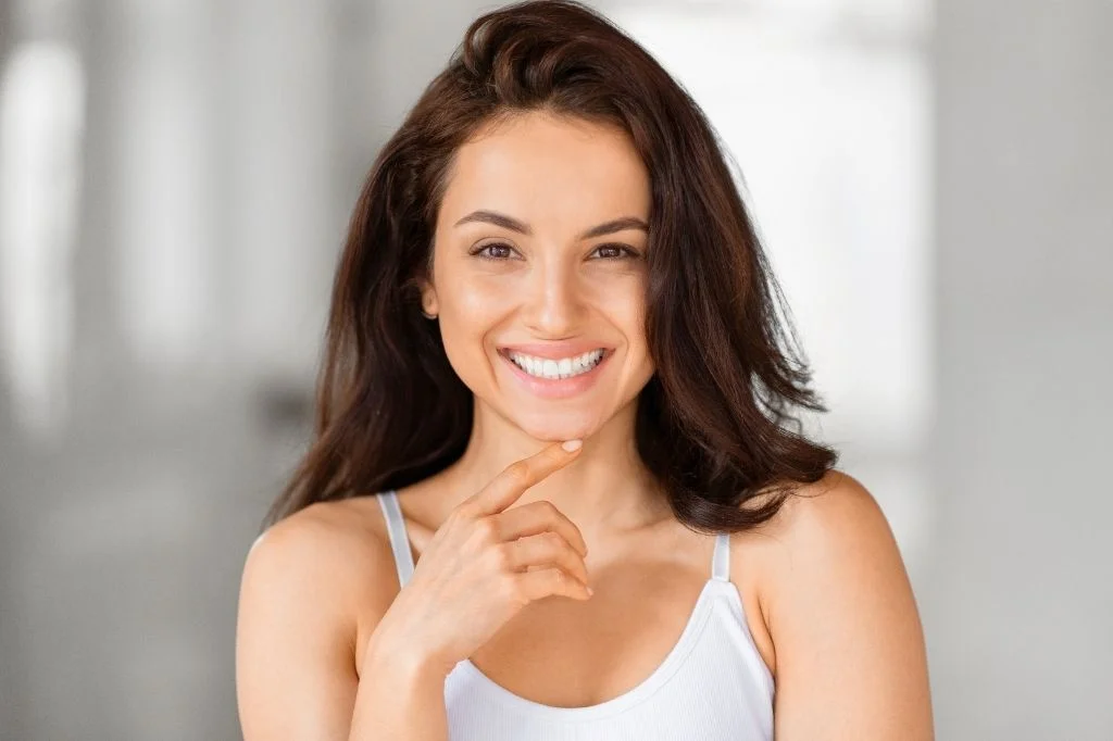 Woman with a natural, expressive smile, representing genuine facial movement after treatment