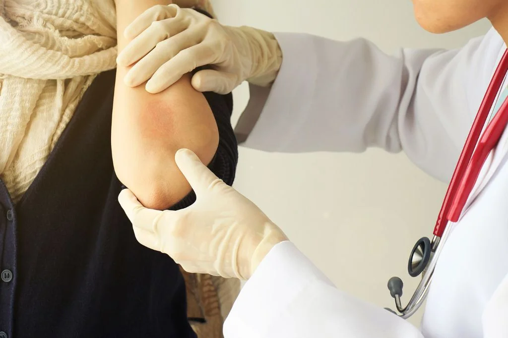 Dermatologist discussing suspected allergy triggers with a patient before testing