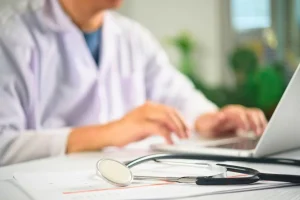 Doctor reviewing patient health history for stem cell therapy eligibility in Bali